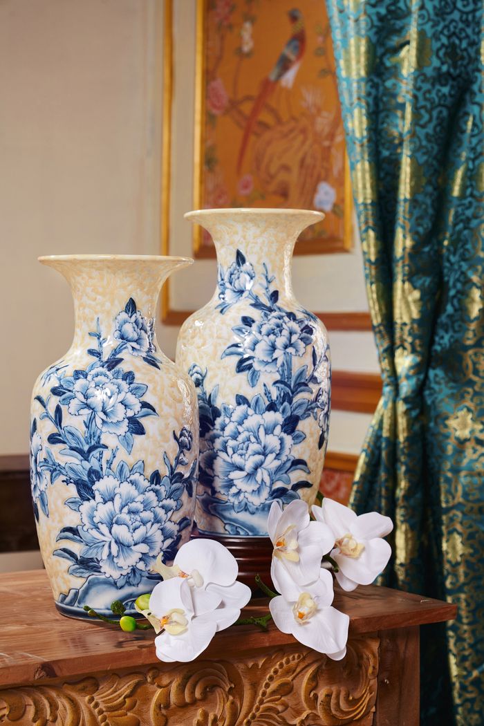 Charming blue floral porcelain vases with white orchids in a luxurious traditional setting.