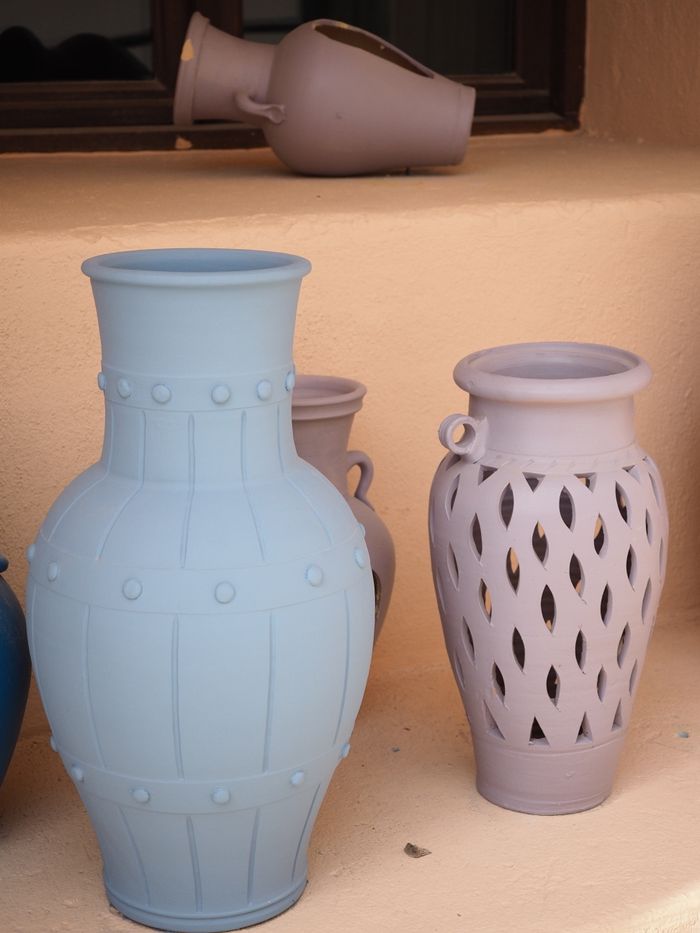 Collection of artistically designed pastel clay vases in Doha, Qatar, showcasing intricate craftsmanship.